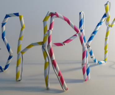 Blue, yellow and red coloured straws bent into creative shapes