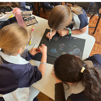 Three students drawing together