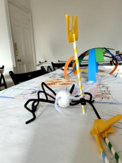 A spider sculpture holding a model fork